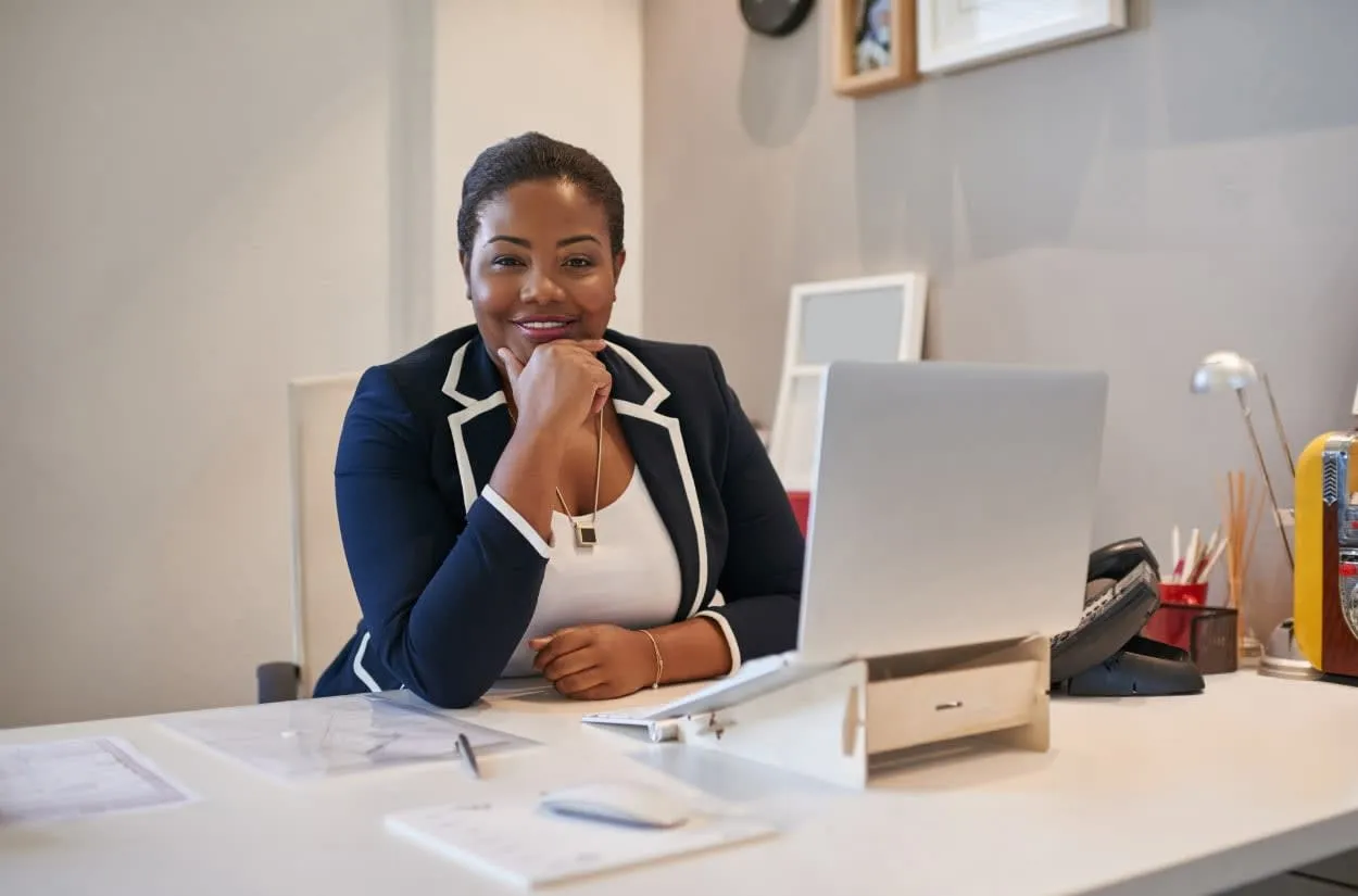 Business owner reviewing finances at her desk