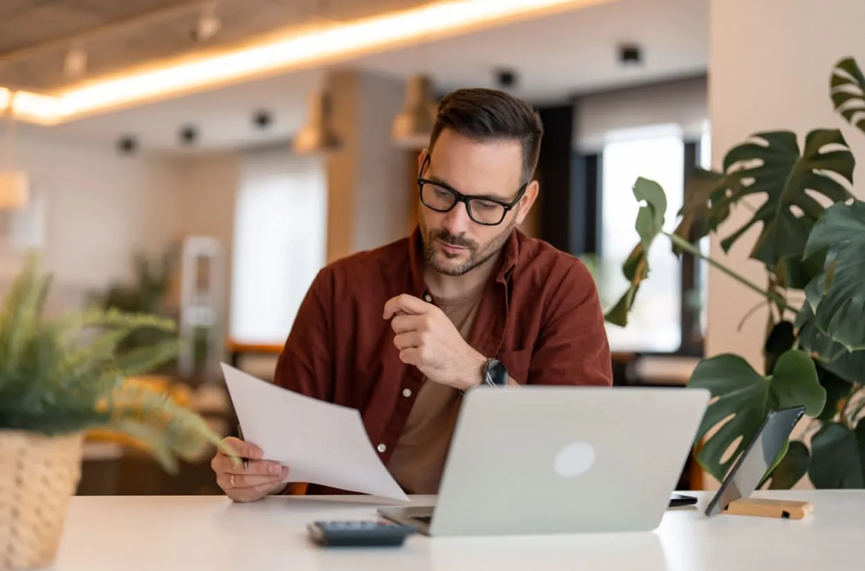 Business owner reviewing financial information on a laptop