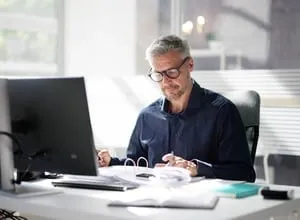 Business owner working at a desk with a laptop