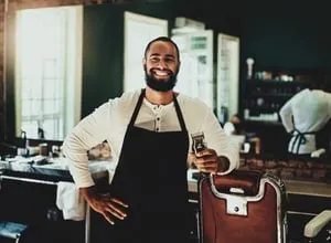 Restaurant owner wearing an apron and smiling