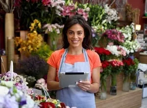 Business owner reviewing papers beside a computer