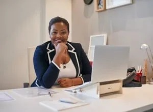 Business owner reviewing financial papers with a laptop