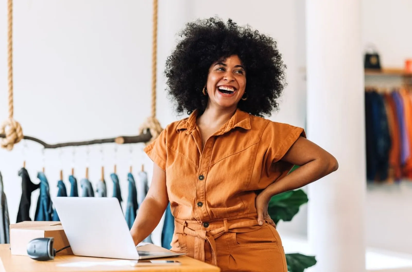 Business owner smiling beside her laptop