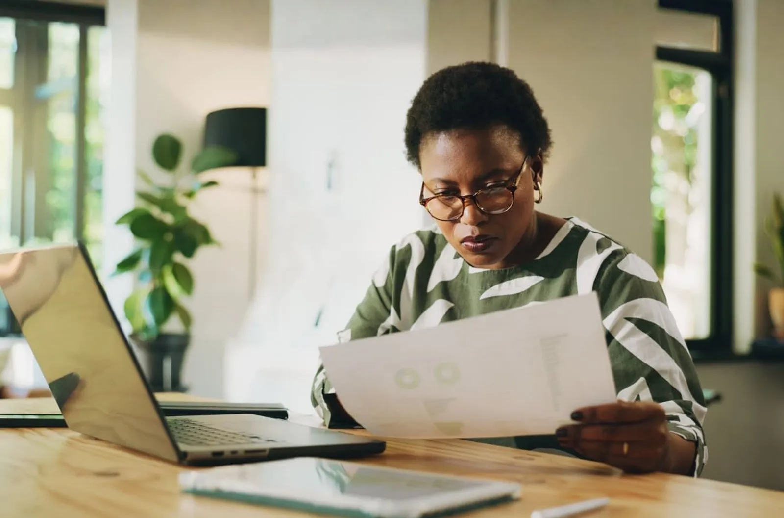 Business owner reviewing paperwork at her desk