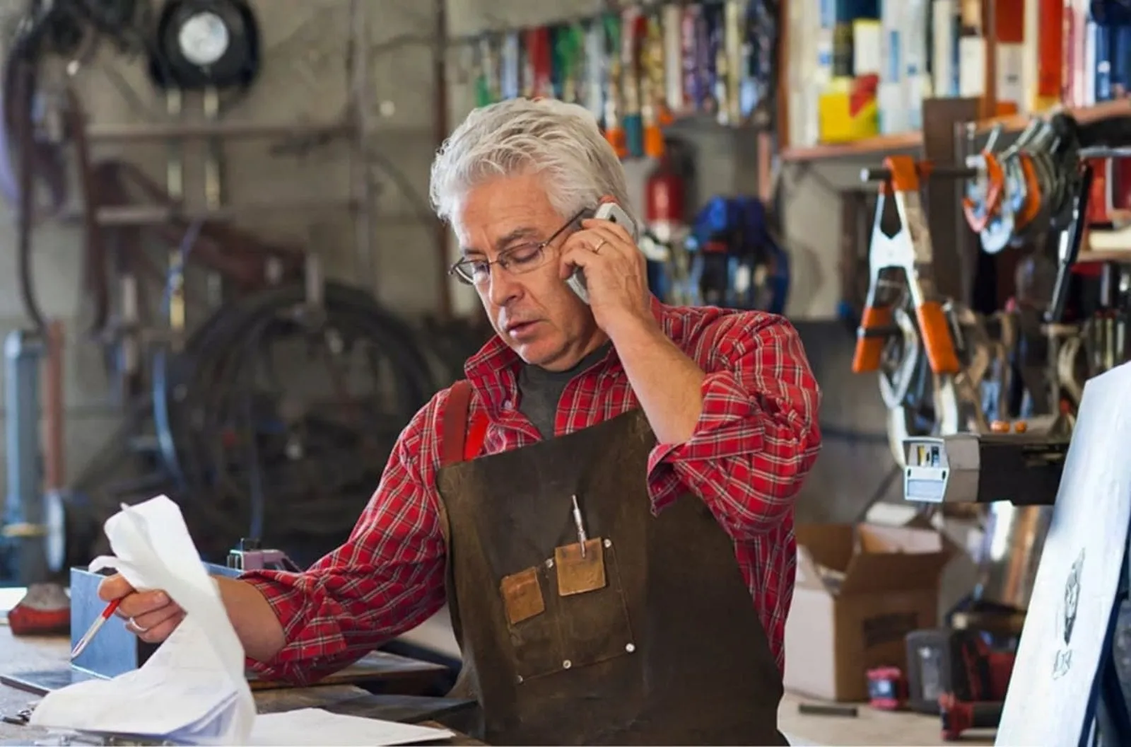 Business owner taking a phone call in his workshop